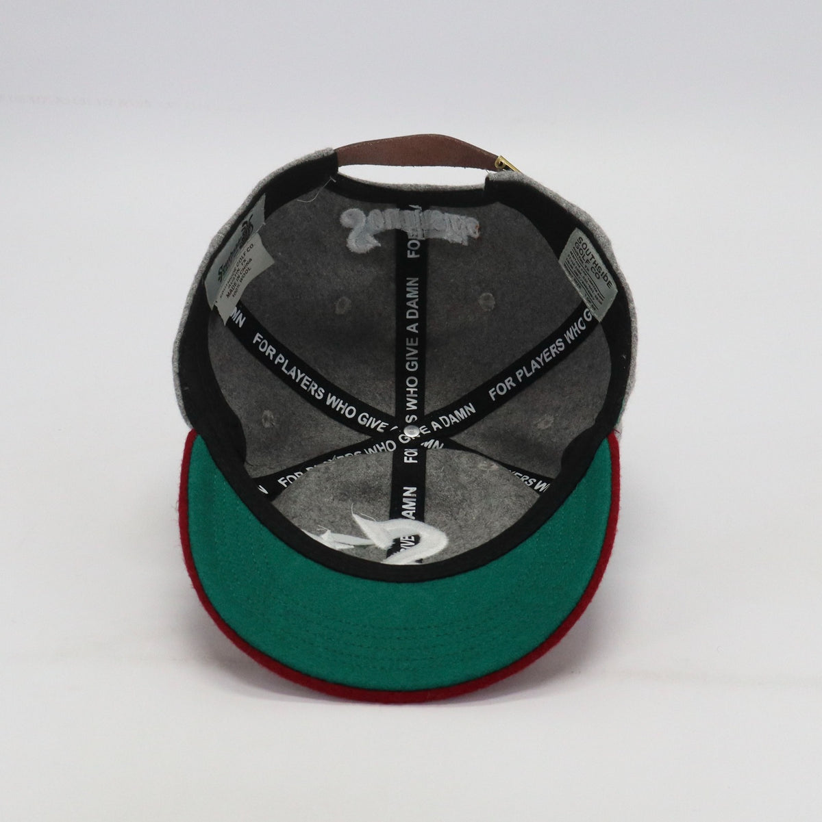 Interior of Southside Golf Co heritage golf hat showing black lining and custom taping for players who give a damn