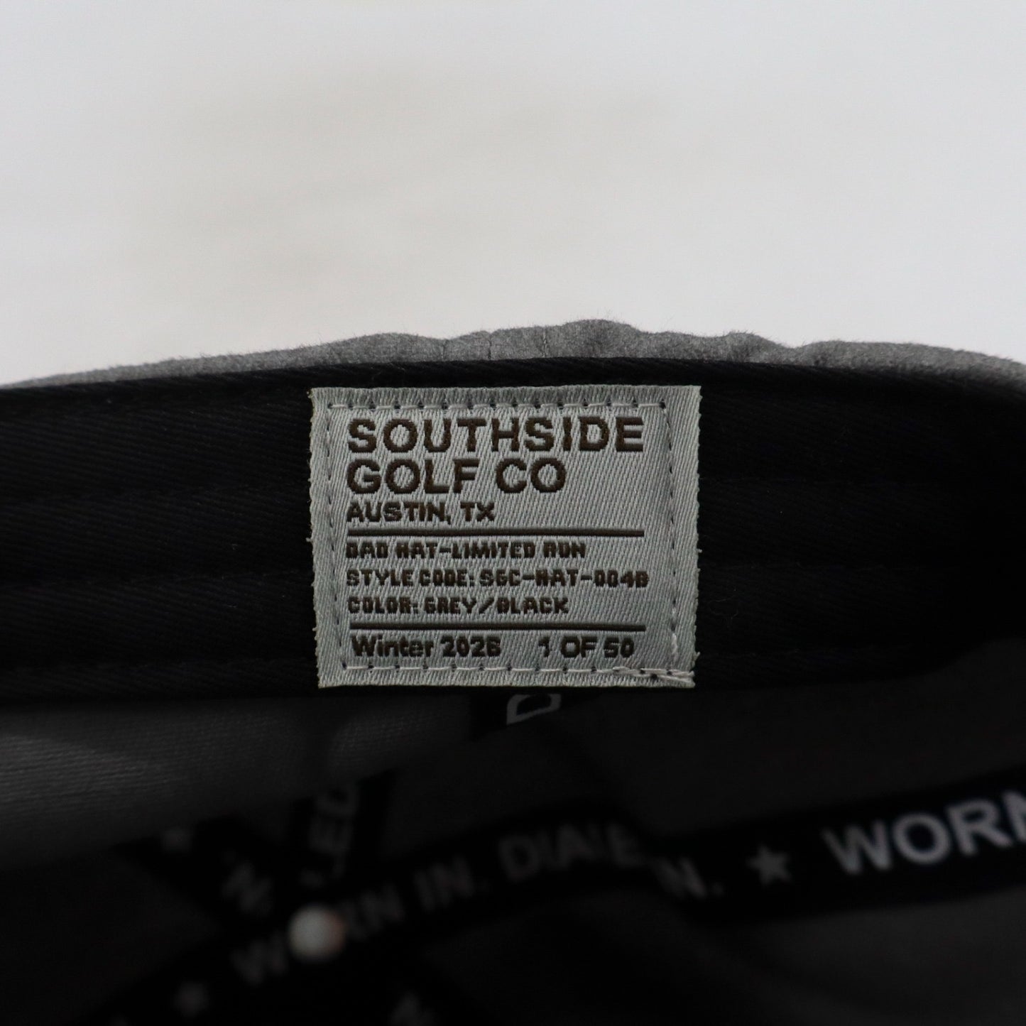 Interior woven label on Southside Golf Co gray dad hat with limited run details and ‘Winter 2026 – 1 of 50’ marking.