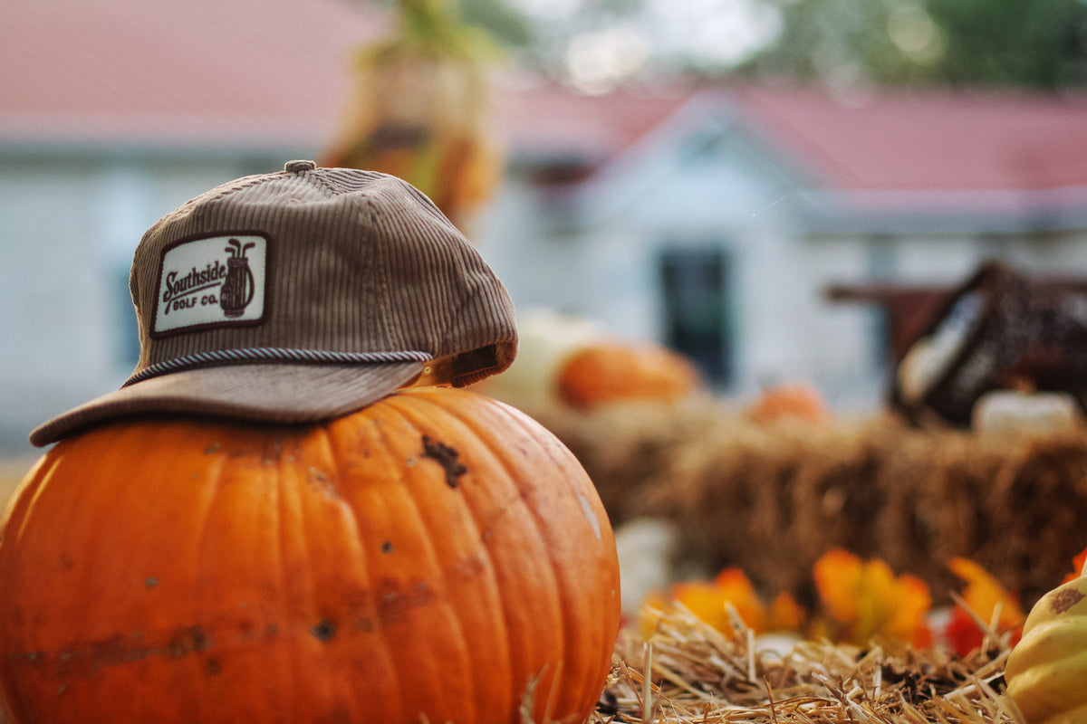 Southside Heritage corduroy 5-panel hat resting on pumpkin at autumn farm setting