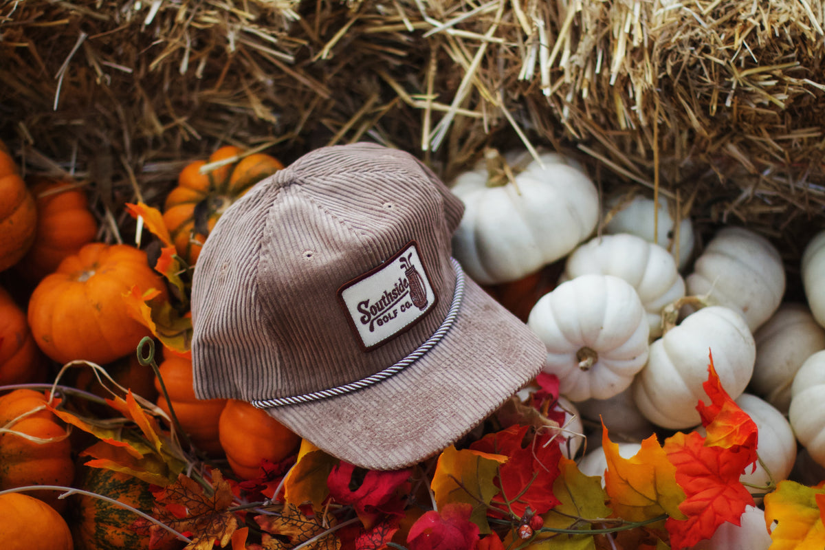 Close-up of Southside Golf Co stitched logo patch on heritage corduroy 5-panel golf hat, premium textured fabric, limited run headwear