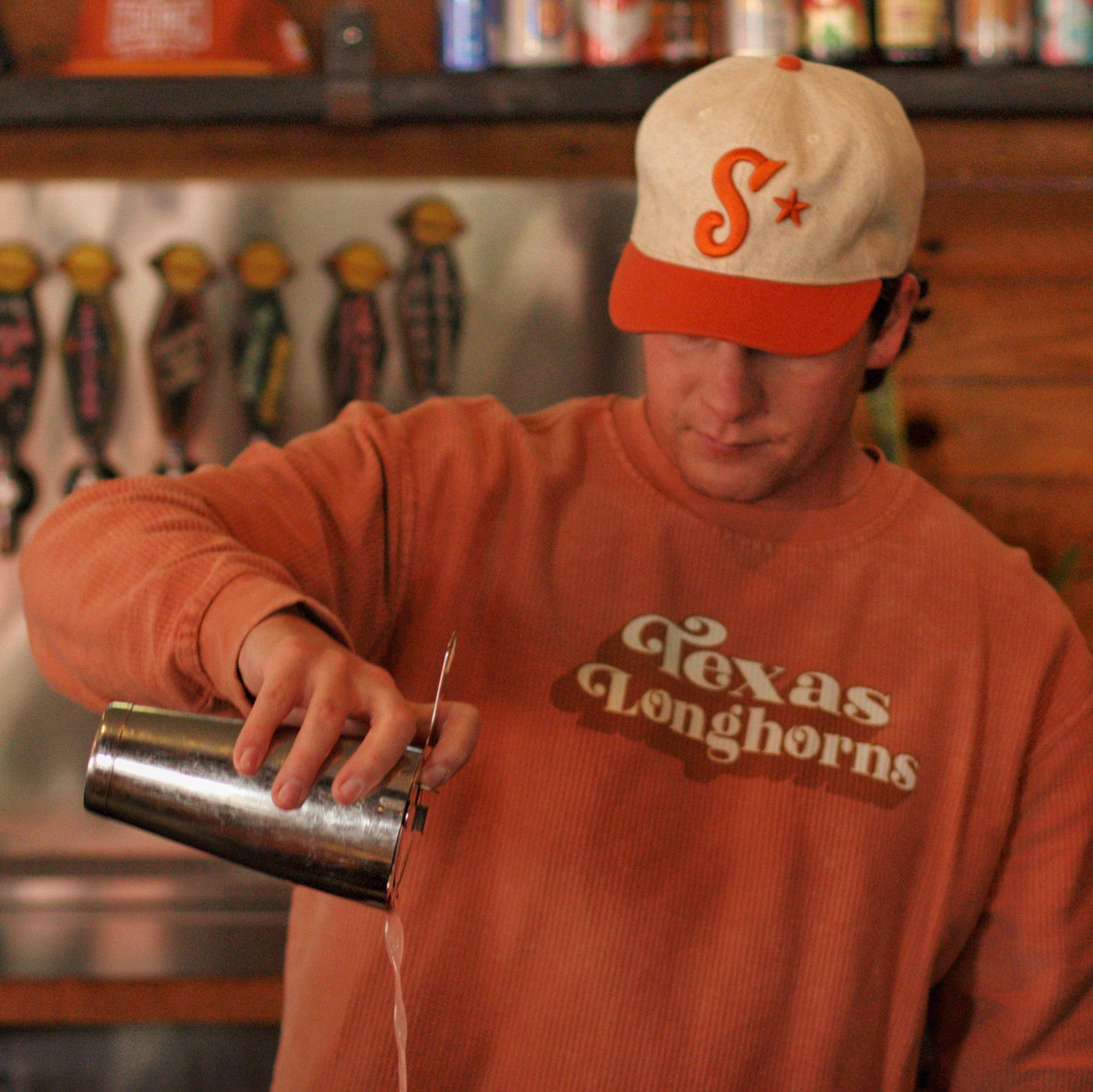 Southside Golf Co cream and burnt orange golf hat with embroidered Southside logo worn in a lifestyle setting.