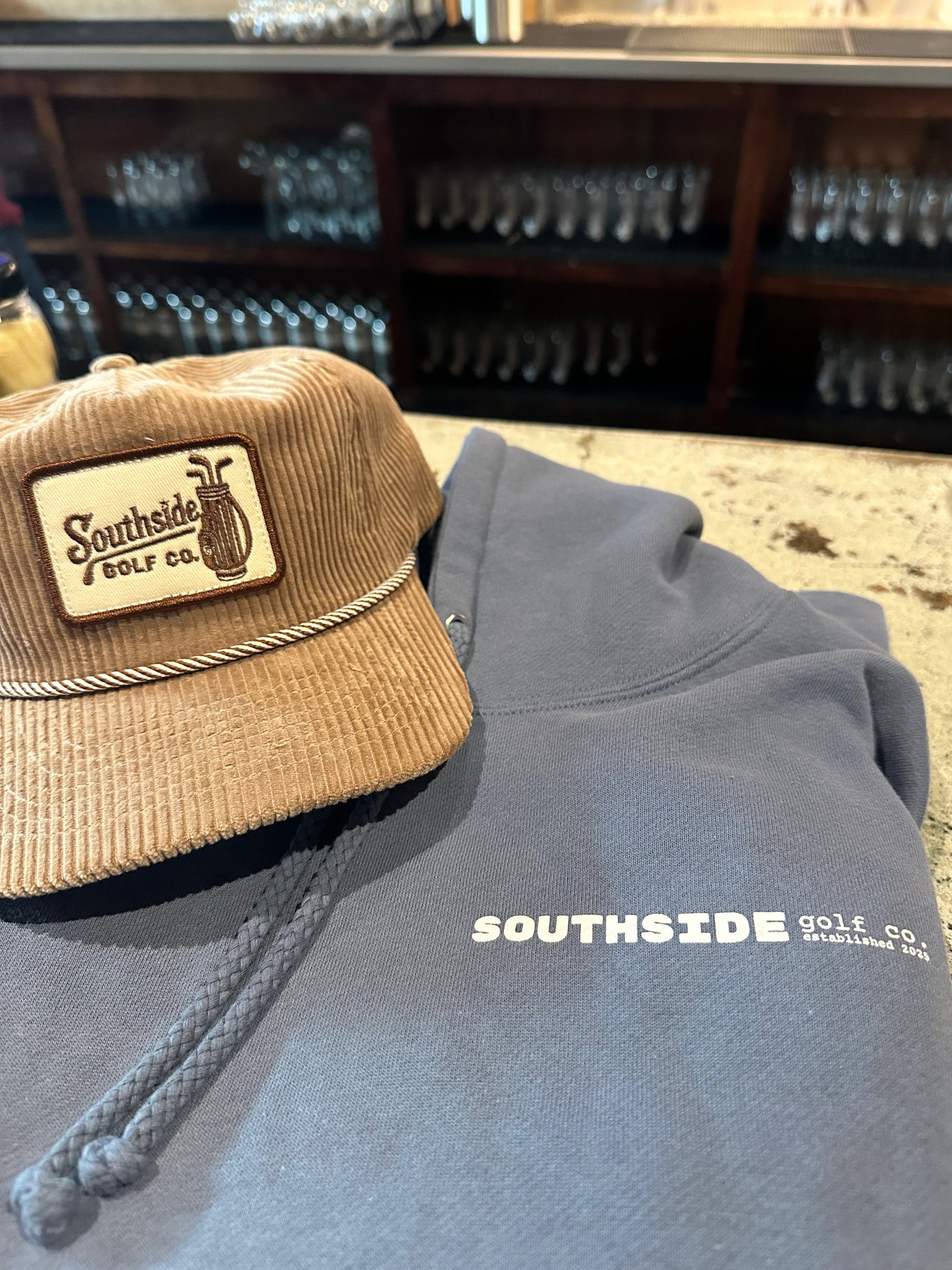 Southside Golf Co hoodie and corduroy cap bundle laid out together