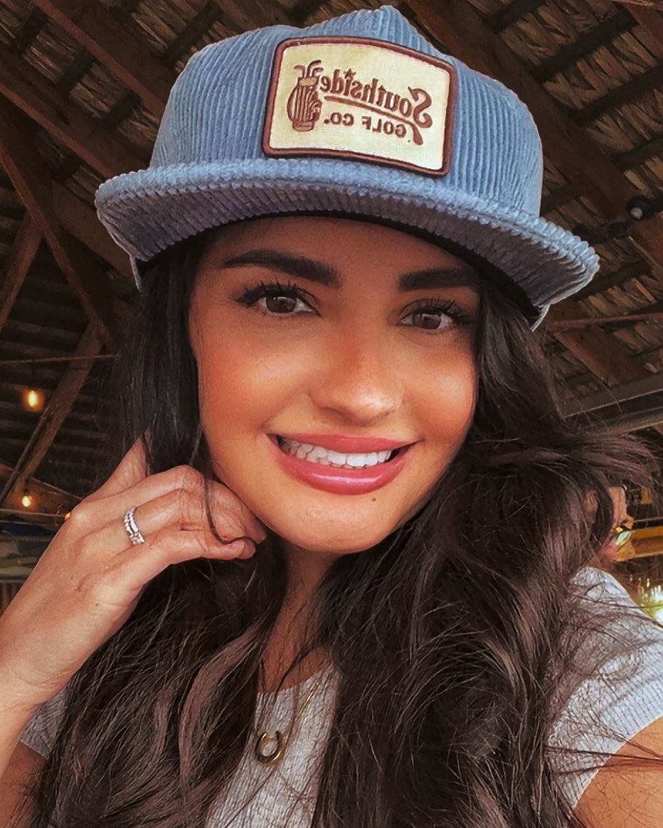woman wearing Southside Golf Co corduroy golf hat with logo casual lifestyle Austin Texas premium golf apparel