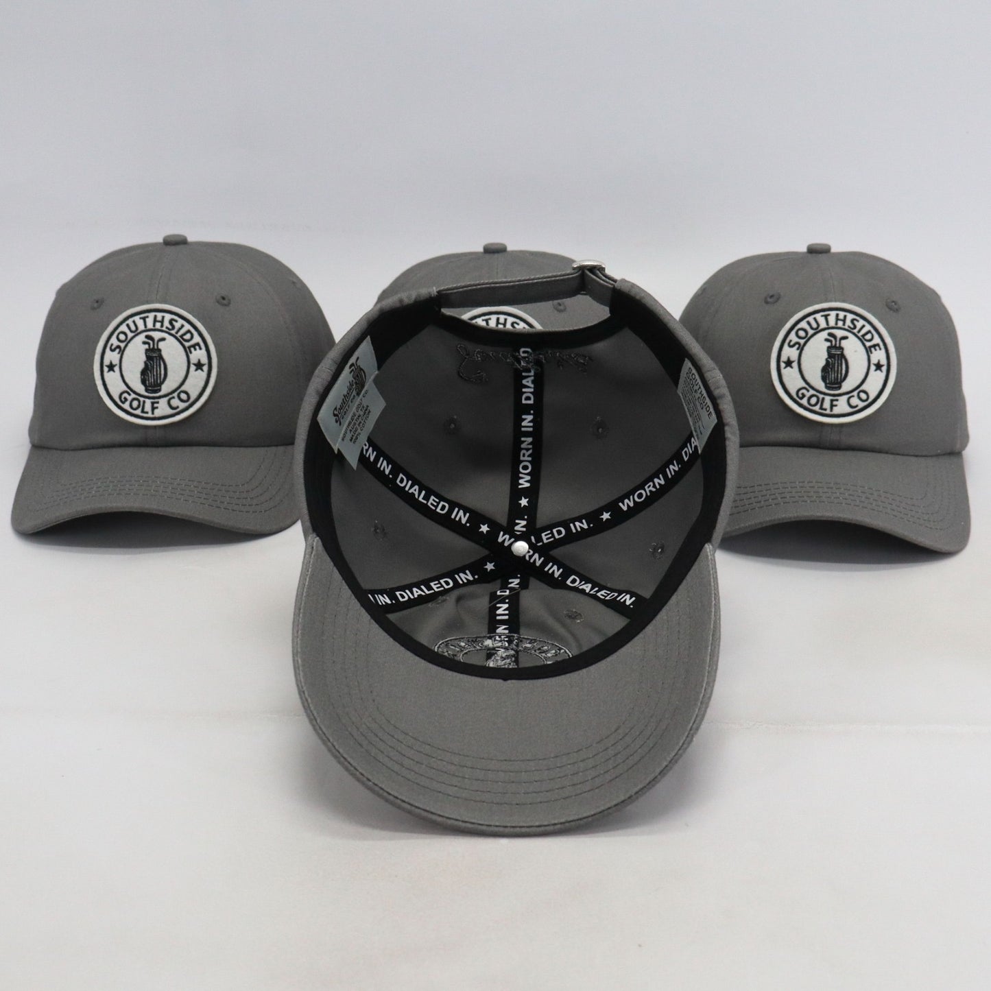 Southside Golf Co gray dad hats showing front logo and interior view with ‘Worn In. Dialed In.’ taping on white background.