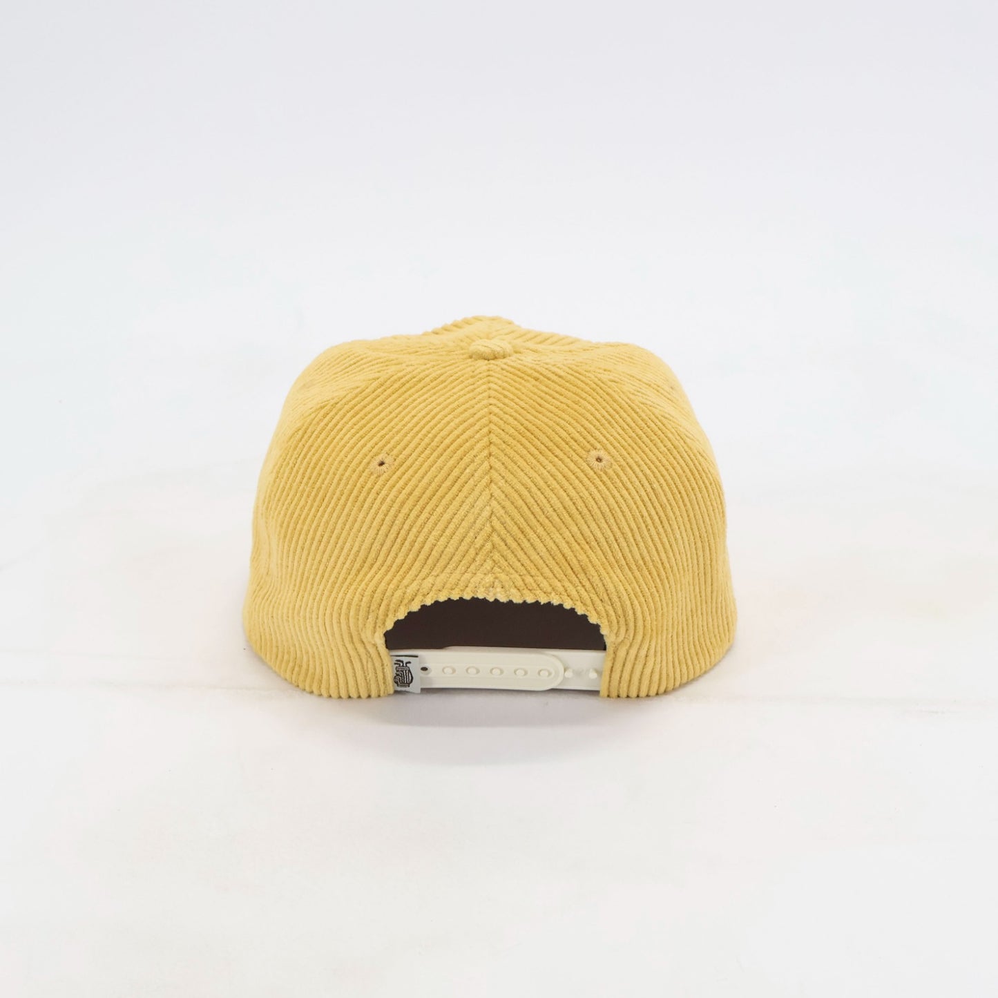 Rear view of Golden Hour yellow corduroy snapback golf hat with cream closure