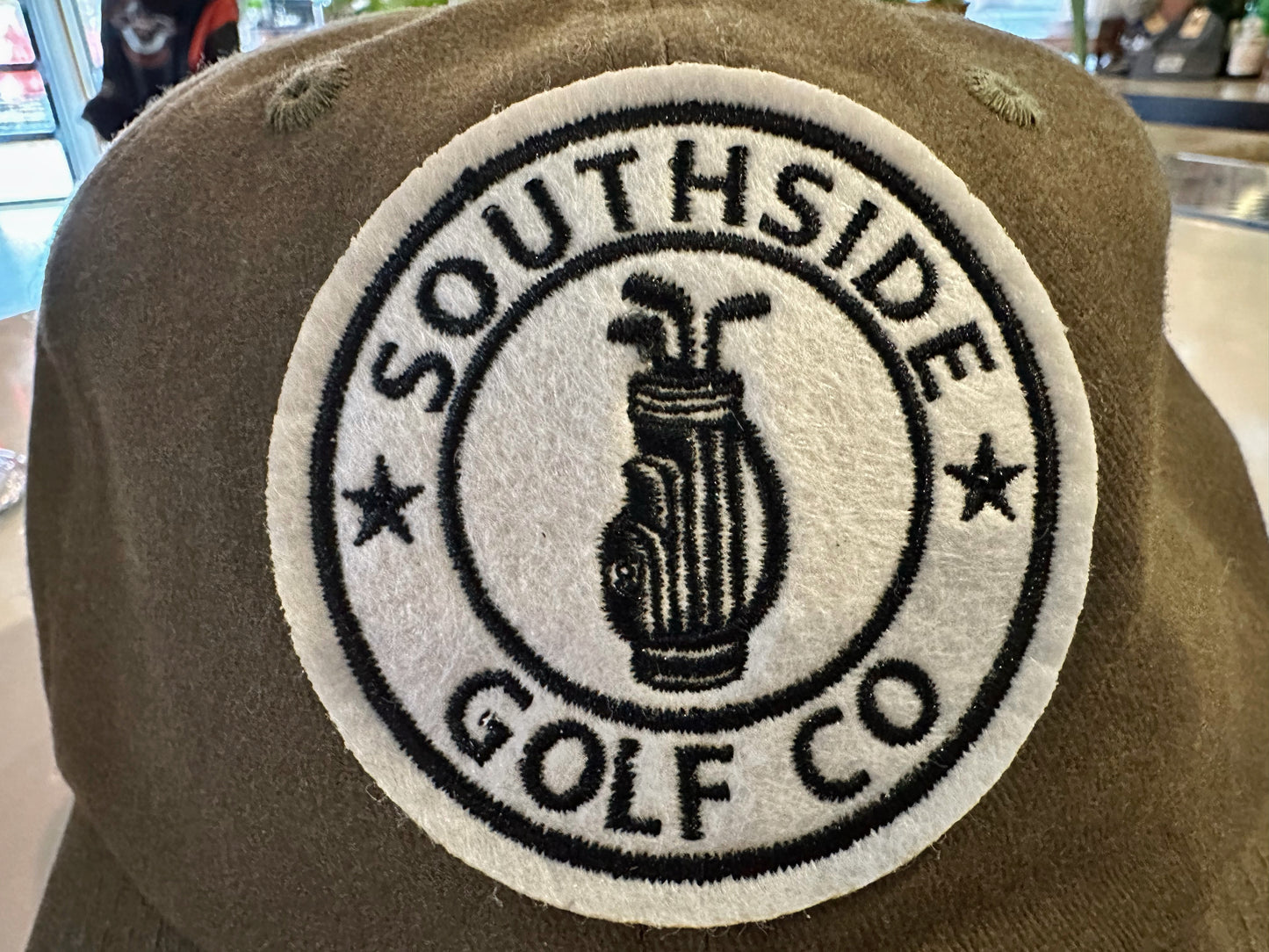 Southside Golf Co olive unstructured golf hat with embroidered logo patch.