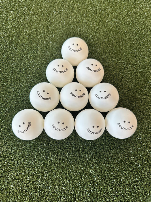 Southside branded white ping pong balls arranged in a pyramid on green turf