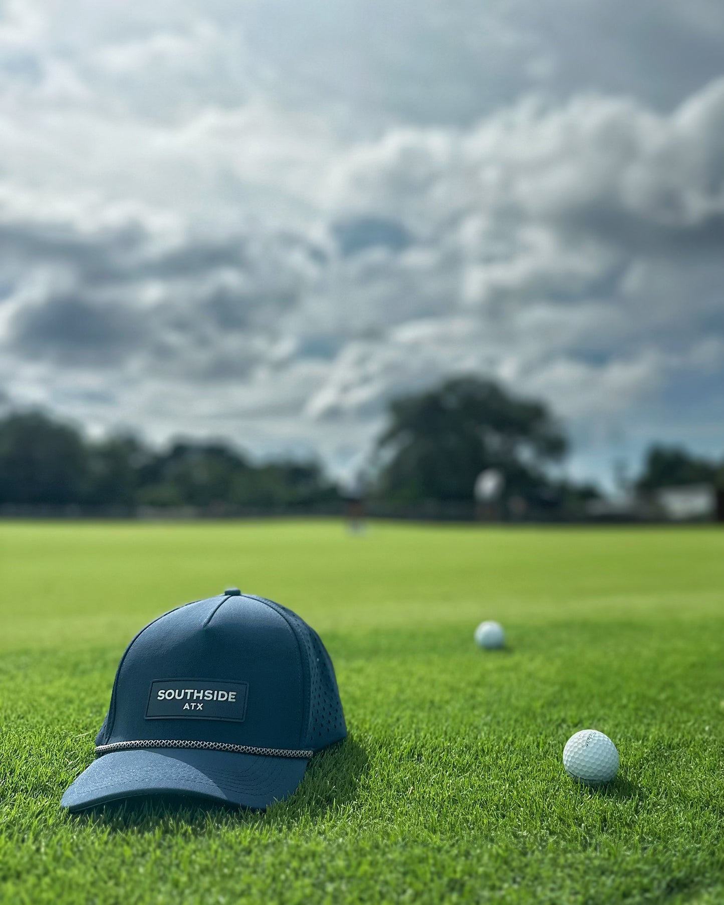 Southside ATX Midnight Navy performance rope golf hat on the practice green at Grey Rock Golf Course in Austin, Texas