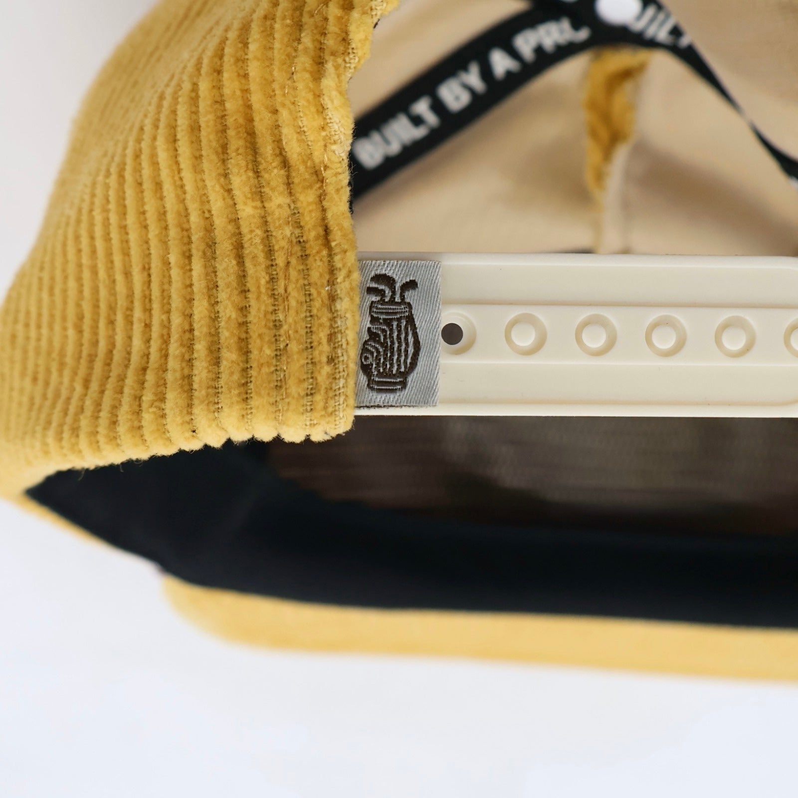 Cream and brown Southside Golf Co woven patch on yellow corduroy golf hat
