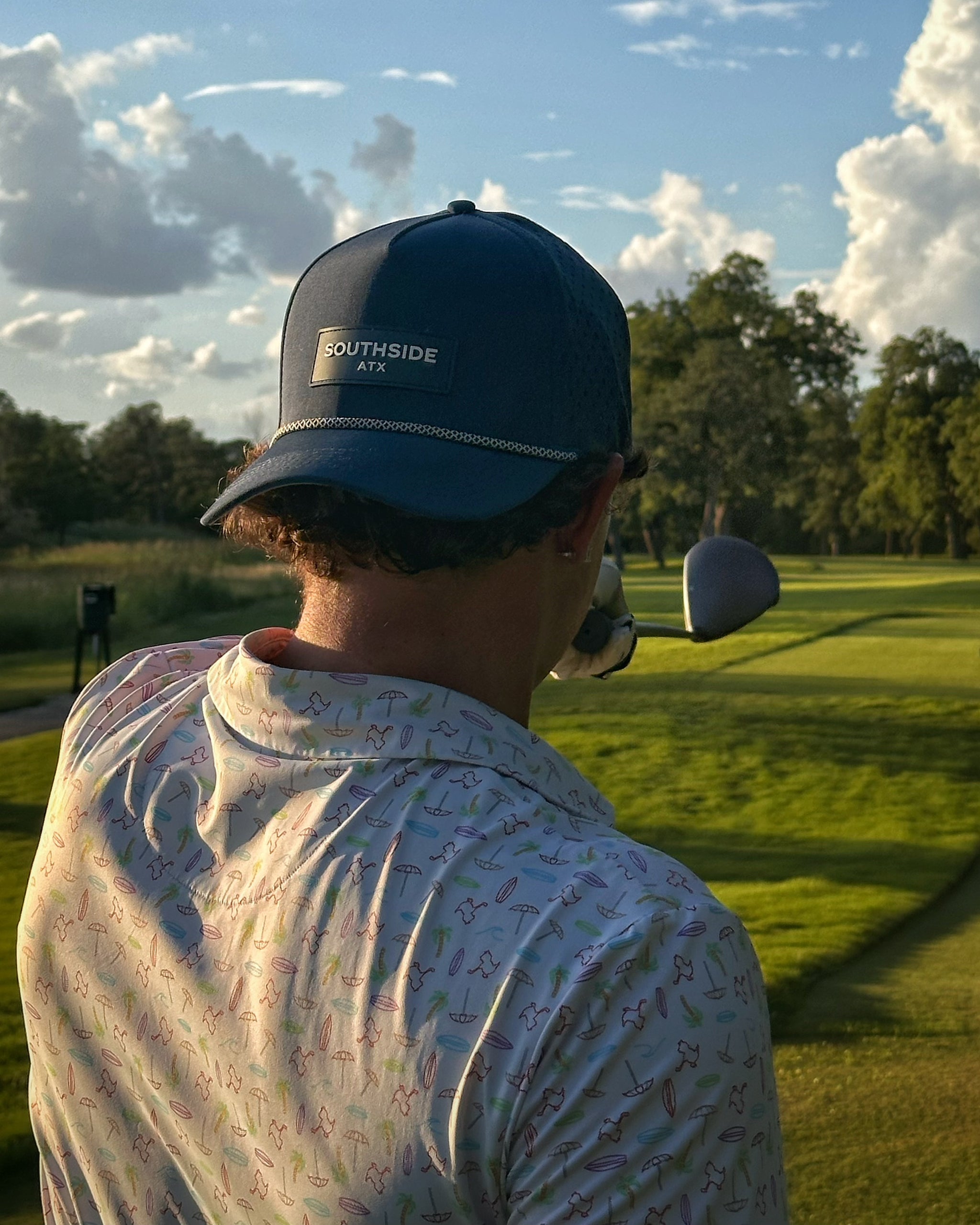 Golfer wearing the southside golf co performance hat while golfing at Onion Creek in Austin, Texas. 
