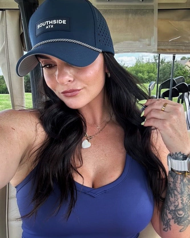 Southside ATX navy performance golf hat worn on a golf course in Austin Texas